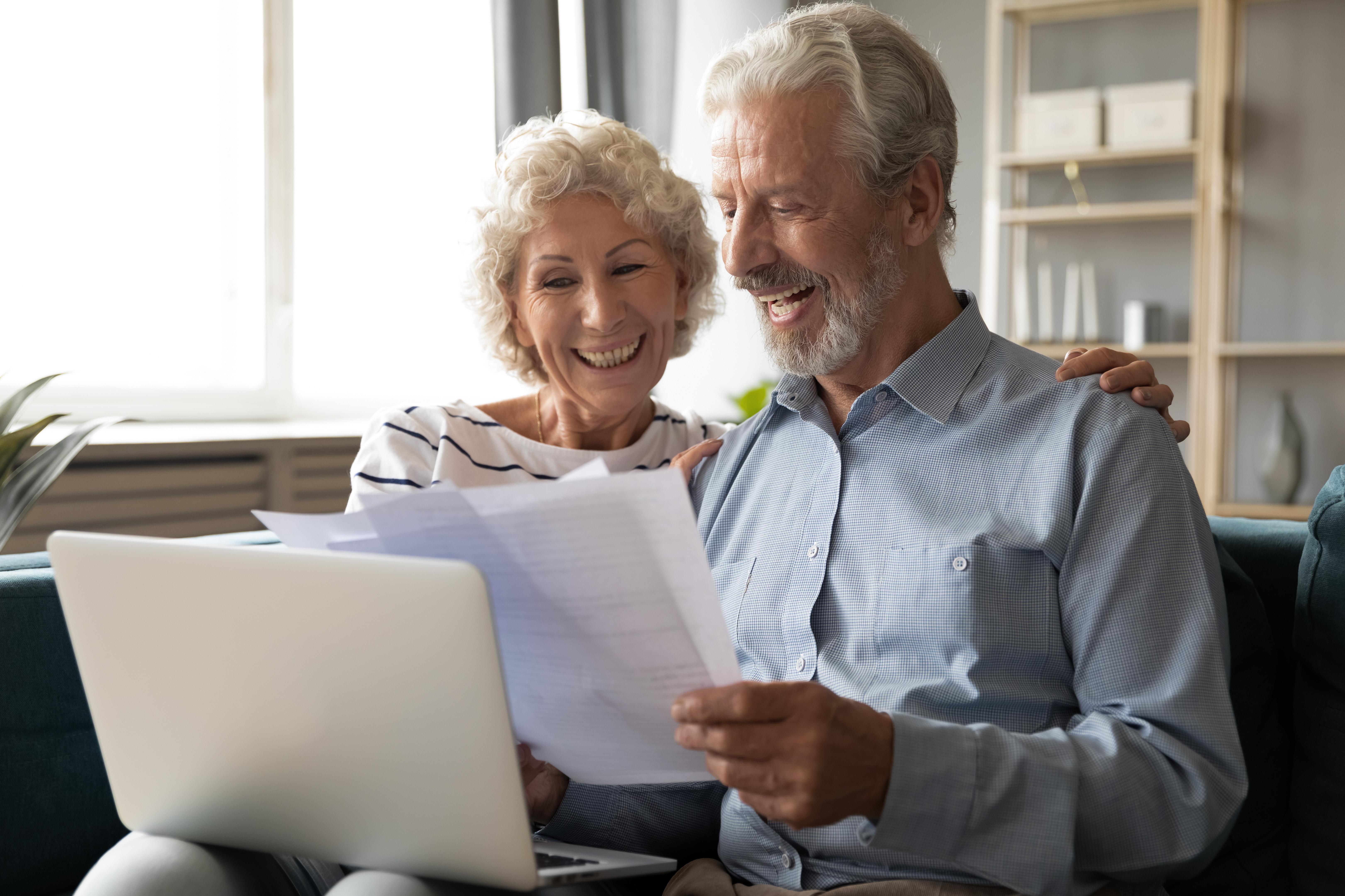 older couple getting results of home energy assessment online